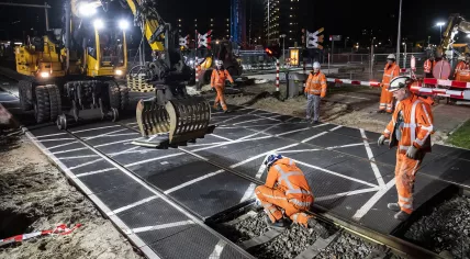 Workers remove a level crossing in Diemen in the early morning hours on 4 March 2023
