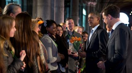 U.S. President Barack Obama is greeted in front of the Rijksmuseum in Amsterdam as Dutch Prime Minister Mark Rutte looks on. 24 March 2014