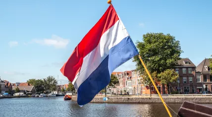 Flag of Netherlands against the backdrop of the river in Haarlem