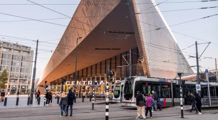 Pedestrians and trams in front of Rotterdam Central Station. October 2011
