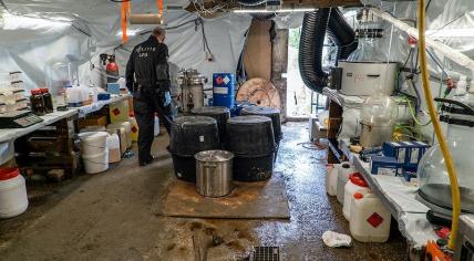 Police officer in a drug lab