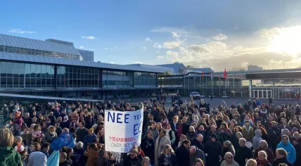 Amsterdam-Zuid locals protest against plans for an erotic center in their district during a district council meeting at the RAI, 12 April 2023