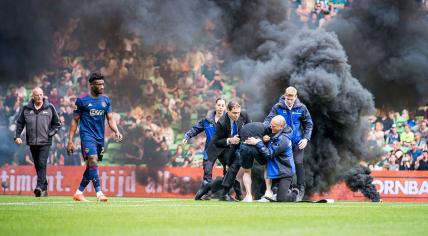 Supporters storm the field during the Dutch premier league match between FC Groningen and Ajax at the Euroborg stadium on May 14, 2023 in Groningen.