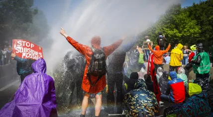 Police deploy a water cannon against Extinction Rebellion activists blocking the A12 in The Hague; May 27, 2023.