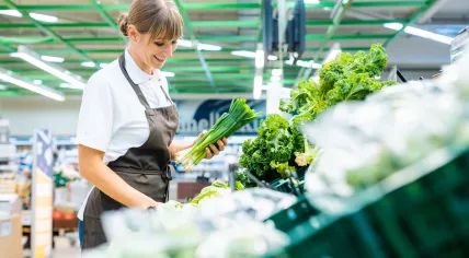 Woman stocking shelves in a supermarket