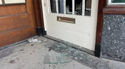 Explosion damaged the door of a nail salon next to the Suri-Change branch on  Eerste van Swindenstraat in Amsterdam Oost, 24 May 2023