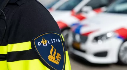Police officer with police cars in the background