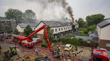 Firefighters fighting a fire in a housing block on Kinsbergenstraat in Arnhem, 18 June 2023