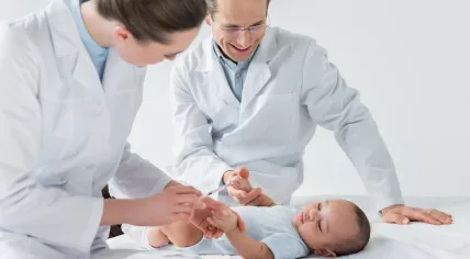 Pediatricians preparing to vaccinate a baby
