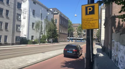 A sign warns drivers of increased paid parking times, and rising fees in the Amsterdam city center. 14 June 2023