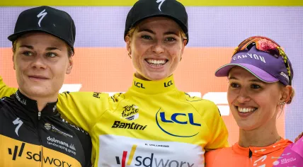Team SD Worx's Belgian rider Lotte Kopecky (L), Team SD Worx's Dutch rider Demi Vollering wearing the overall leader's yellow jersey (C) and Canyon SRAM Racing's Polish rider Katarzyna Niewiadoma celebrate on the general ranking podium at the end of the eighth and final stage of the Tour de France Femmes, 30 July 2023