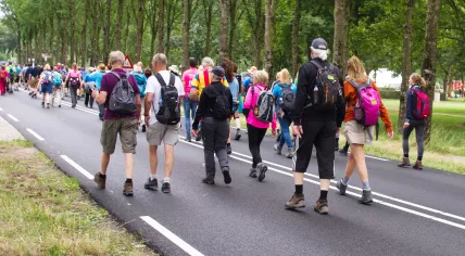 People walking into Arnhem, about 12 kilometers north of Nijmegen, at the start of the Vierdaagse on 16 July 2019