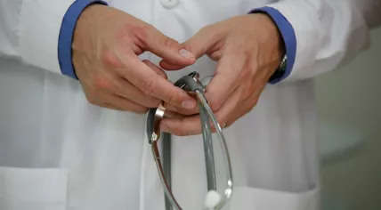 A physician is holding his stethoscope