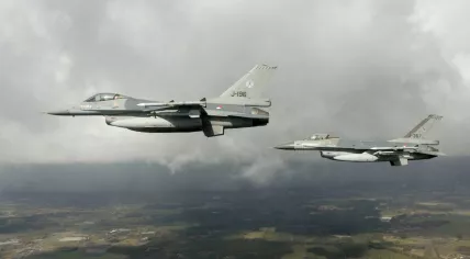 Two Dutch F-16 fighter jets in the air