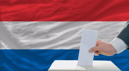 Ballot box in front of a Dutch flag 