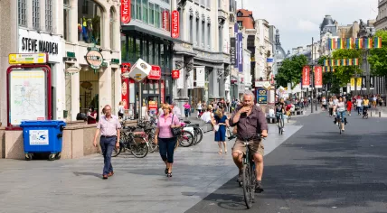 People and cyclists in main shopping street of Antwerp, Belgium