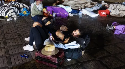Residents take shelter outside at a square following an earthquake in Marrakesh on September 9, 2023. 