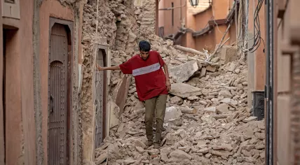A resident navigates through the rubble following a 6.8-magnitude quake in Marrakesh on September 9, 2023