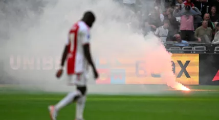 Ajax supporters throw fireworks onto the field during the Dutch Eredivisie match between Ajax and Feyenoord in the Johan Cruijff ArenA on 24 september 2023 in Amsterdam, Netherlands. 