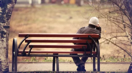 Lonely man sitting on a bench.