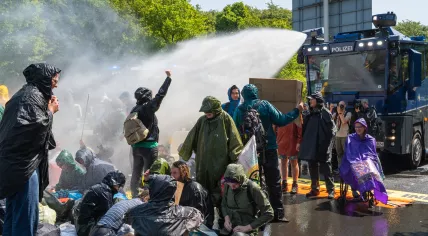 Police deploy a water cannon against Extinction Rebellion activists blocking the A12 in The Hague; May 27, 2023.
