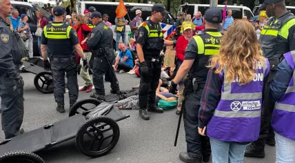 Extinction Rebellion protesters facing arrests by the police during A12 blockade in The Hague. 