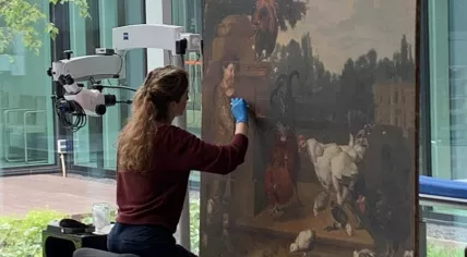 An employee of the Cultural Heritage Agency of the Netherlands restoring an artwork in the Dutch Art Collection