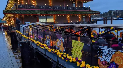 Boat on the Oosterdokskade during the Day of the Dead boat parade in Amsterdam. October 2022.