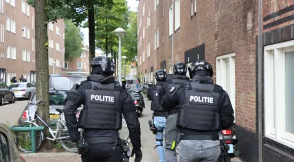 Police officers on Marco Polostraat in Amsterdam, where a shooting happened after a car struck and injured an officer, October 9, 2023.