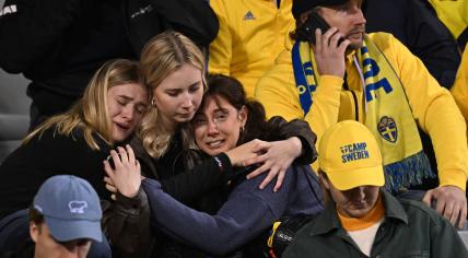 Swedish supporters react as they wait in the stand during the Euro 2024 qualifying football match between Belgium and Sweden at the King Baudouin Stadium in Brussels on October 16, 2023, after an attack that targeted Swedish citizens.