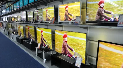 Wall of flat screen televisions in the electronics section of a store