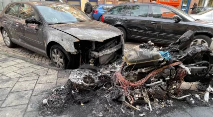 Aftermath of a fire on Derde Oosteparkstraat in Amsterdam on 18 October 2023. A motorcycle is almost completely burnt out and a car is damaged