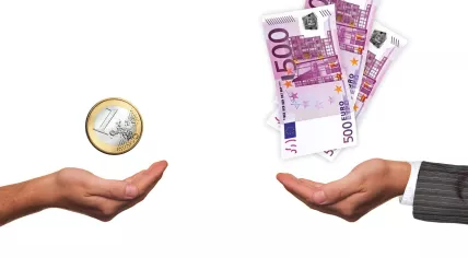 A single euro in one hand, vs 1,500 euros held by someone wearing a suit