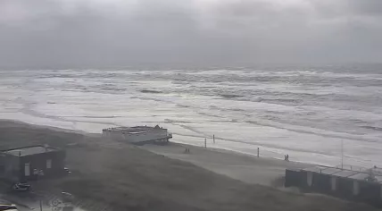 People walk on the beach in Egmond aan Zee as storm-force winds arrive. 24 Nov 2023