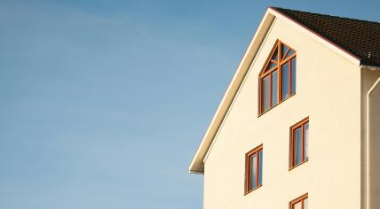 A beige home against a blue sky