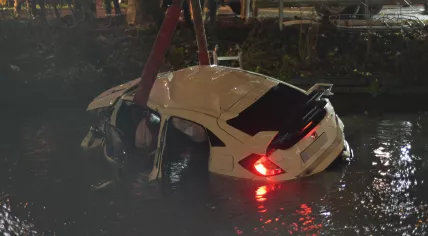  A car is towed out of the water in Delft after it fell into it for unknown reasons. 