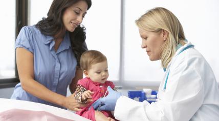 Doctor vaccinating a baby girl