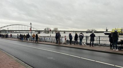 People walk past sandbag reinforcements on the Welle, a quay along the IJssel River, in Deventer. 27 December 2023