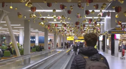 A passenger walking though Schiphol Airport during the Christmas 2023 holiday period