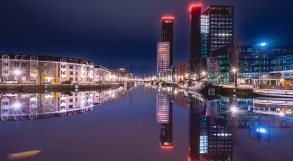 Looking east on Willemskade, the Achmeatoren and the Averotoren light up the skyline in Leeuwarden, Friesland. February 2023