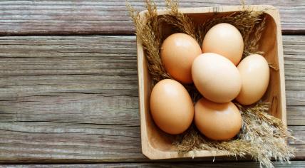 Brown chicken eggs in a wooden container