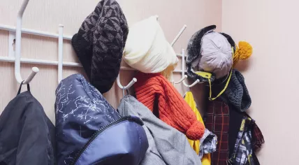 Winter wear hanging on hooks in a corridor