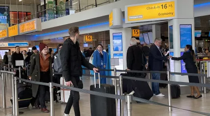 Passengers lining up at a KLM check-in point at Schiphol Airport. 8 May 2023