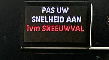 An electronic traffic sign in Amsterdam warning road users to adjust their speed due to snowfall, 16 January 2023