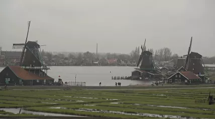 Tourists visit the windmills of the Zaanse Schans in Zaandam on a dreary morning. 2 January 2024