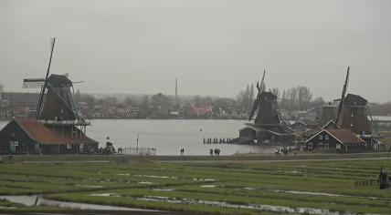 Tourists visit the windmills of the Zaanse Schans in Zaandam on a dreary morning. 2 January 2024