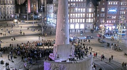 People begin to arrive at a memorial for Russian opposition leader Alexei Navalny at the National Monument on Dam Square in Amsterdam hours after his death at the age of 47. 16 February 2024