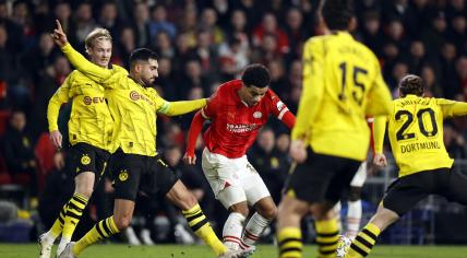 Emre Can of Borussia Dortmund, Malik Tillman of PSV Eindhoven during the UEFA Champions League last 16 match between PSV Eindhoven and Borussia Dortmund at Phillips Stadium on February 20, 2024 in Eindhoven, Netherlands.