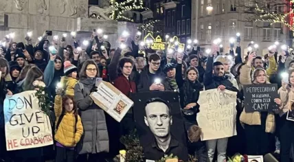 People at a memorial for Russian opposition leader Alexei Navalny at the National Monument on Dam Square in Amsterdam.