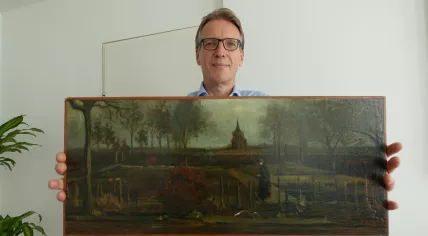 Art detective Arthur Brand poses with the stolen Vincent van Gogh painting he helped recover, "Parsonage Garden at Nuenen in Spring", at his Amsterdam home. 11 September 2023